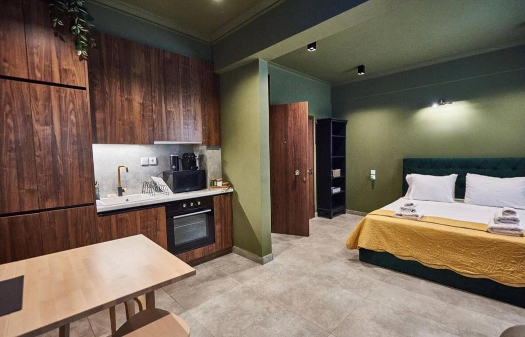 a small room with a bed and a kitchen at Bari in Acropolis in Athens