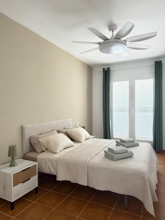a bedroom with a bed with a ceiling fan at Heavenly Homes Mojacar 75 in Mojácar