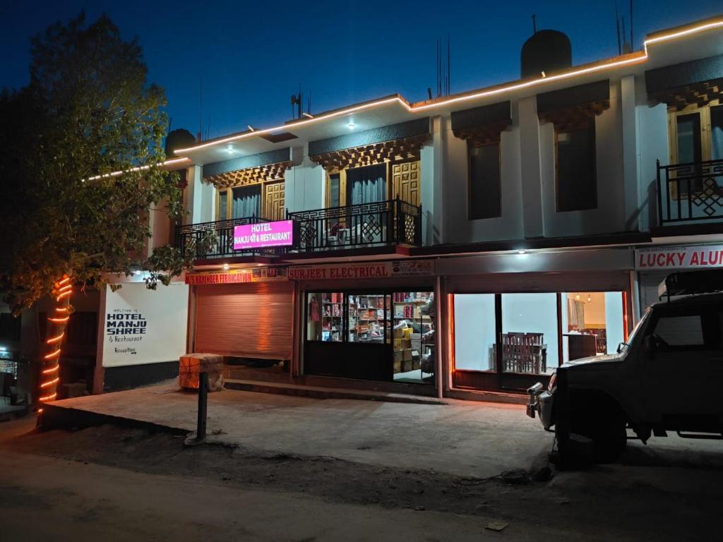 a building with a parking lot in front of it at Hotel Kaza Manjushree in Kaza