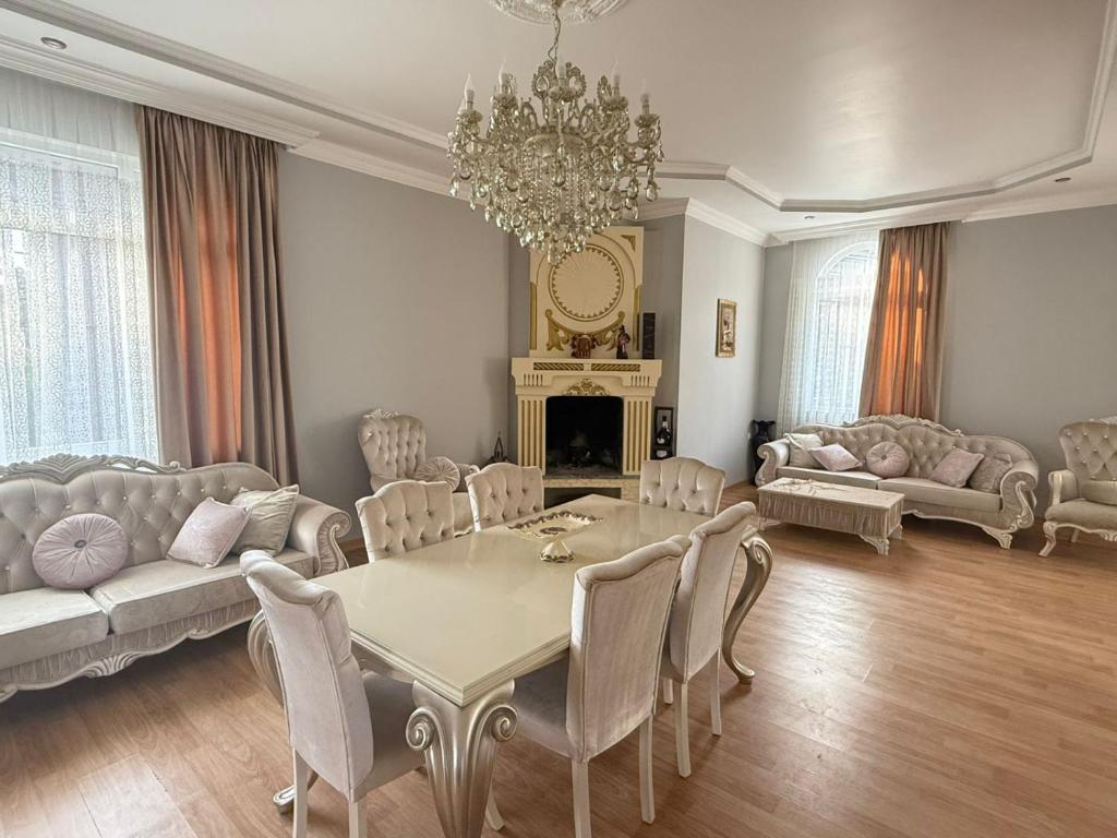 a living room with a table and chairs and a chandelier at Petra Tsikhisdziri in Ts'ikhisdziri