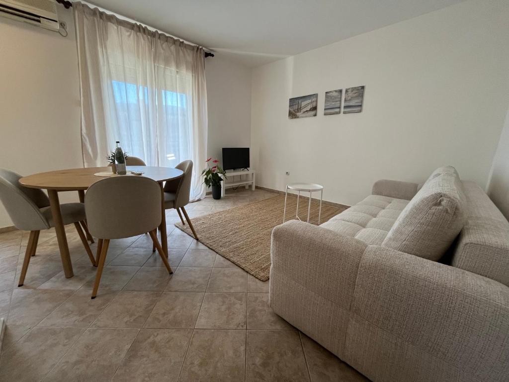 a living room with a couch and a table at Galeb in Igalo