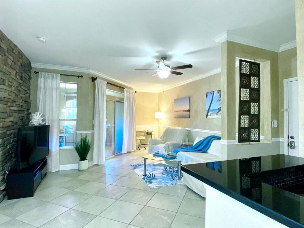 a kitchen and living room with a ceiling fan at Avalon, Clearwater in Clearwater