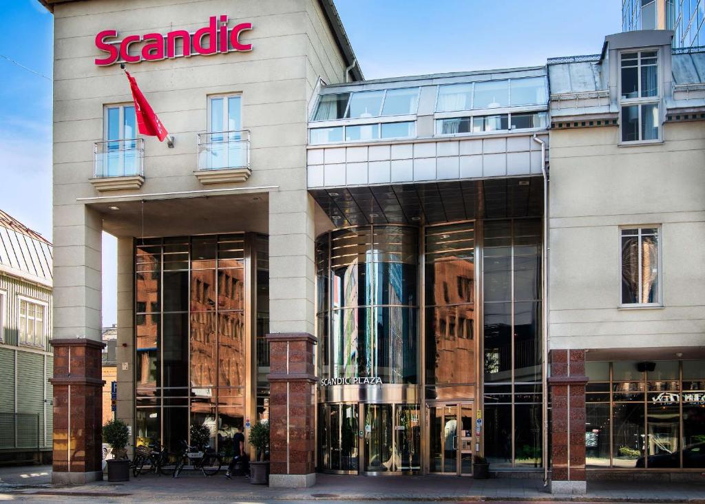 a store front of a building with a sign on it at Scandic Plaza Umeå in Umeå
