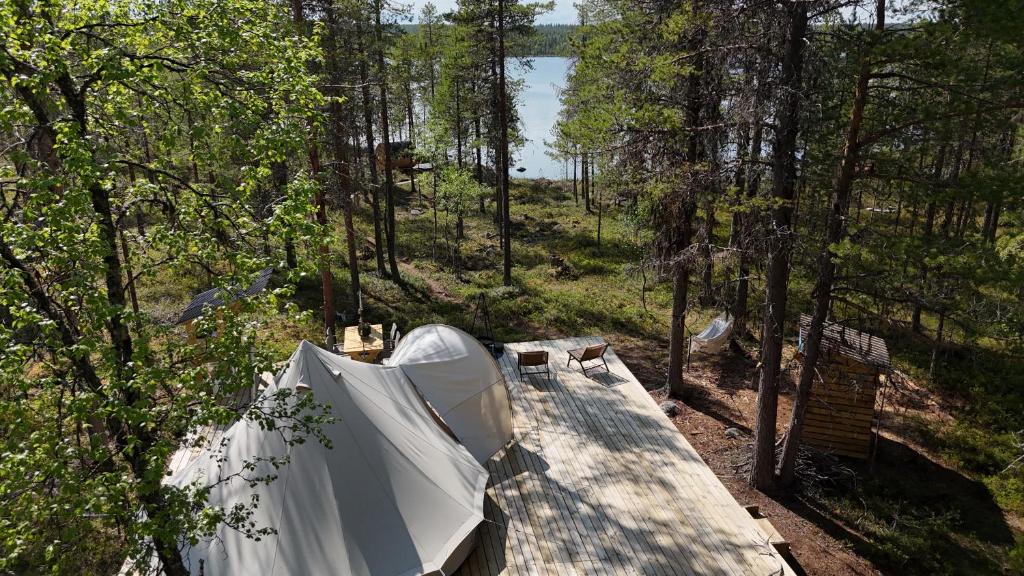 an overhead view of a tent in the woods at LaplandLiv Glampingtent with private sauna at the lake! in Mellanström