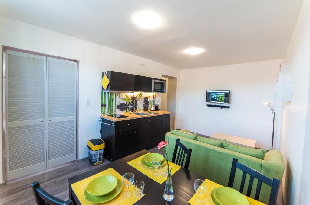 a living room with a dining table and a kitchen at Apartment AndruL in Frymburk