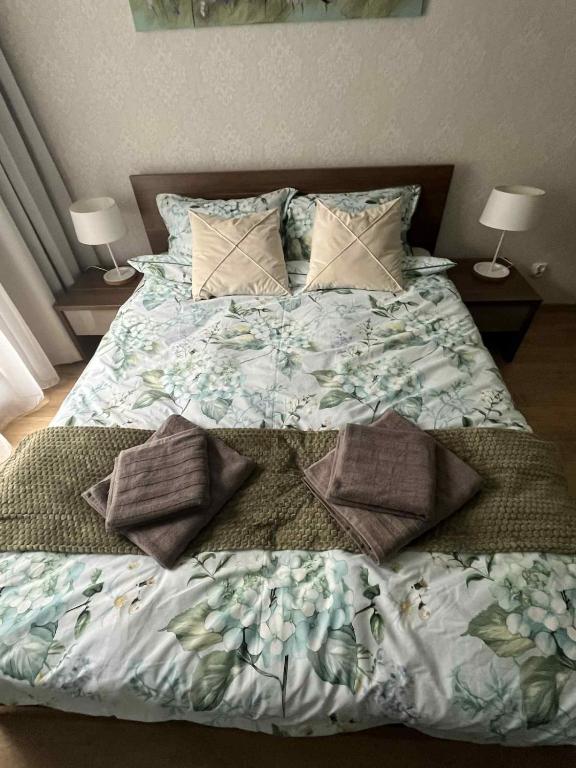 a bed with pillows on it in a bedroom at Przystań La Motława in Gdańsk