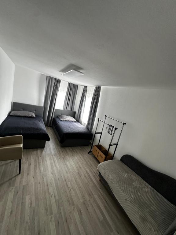 a bedroom with two beds and a wooden floor at Zimmervermietung Wels in Wels