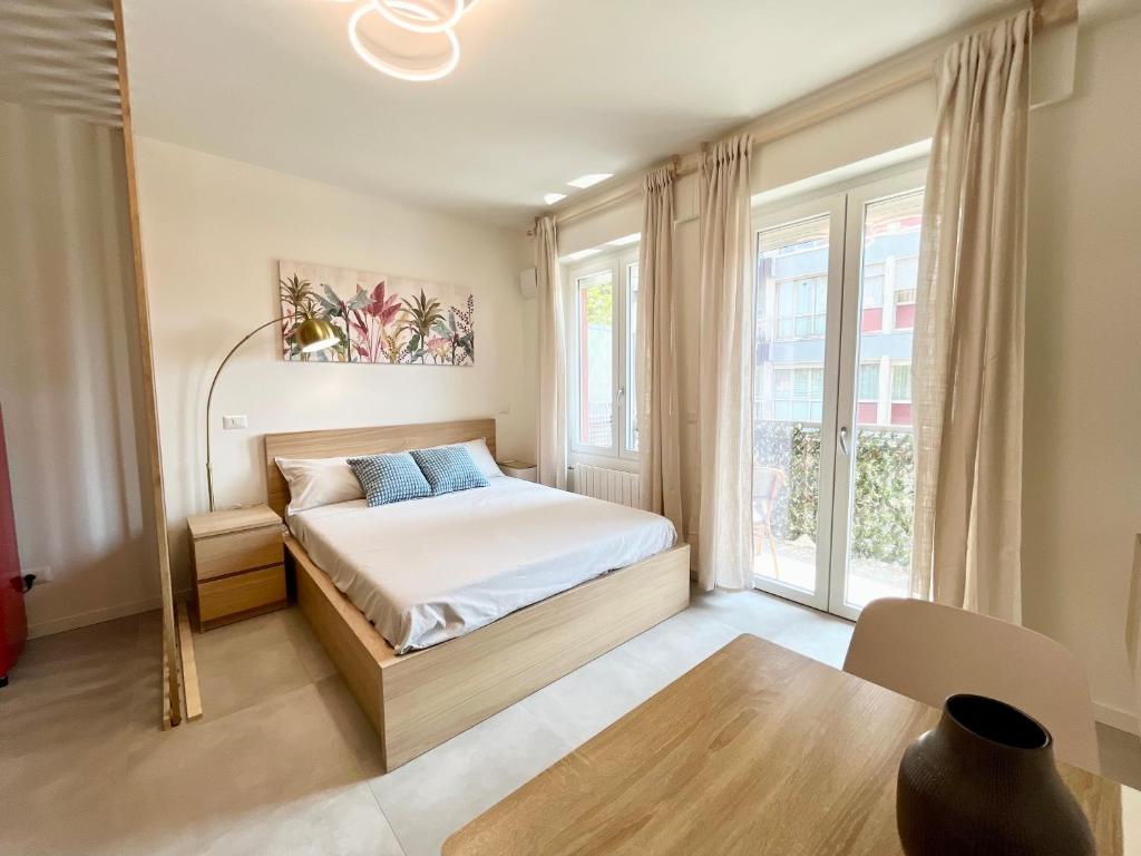 a bedroom with a bed and a large window at Suardi Residence 2 in Bergamo
