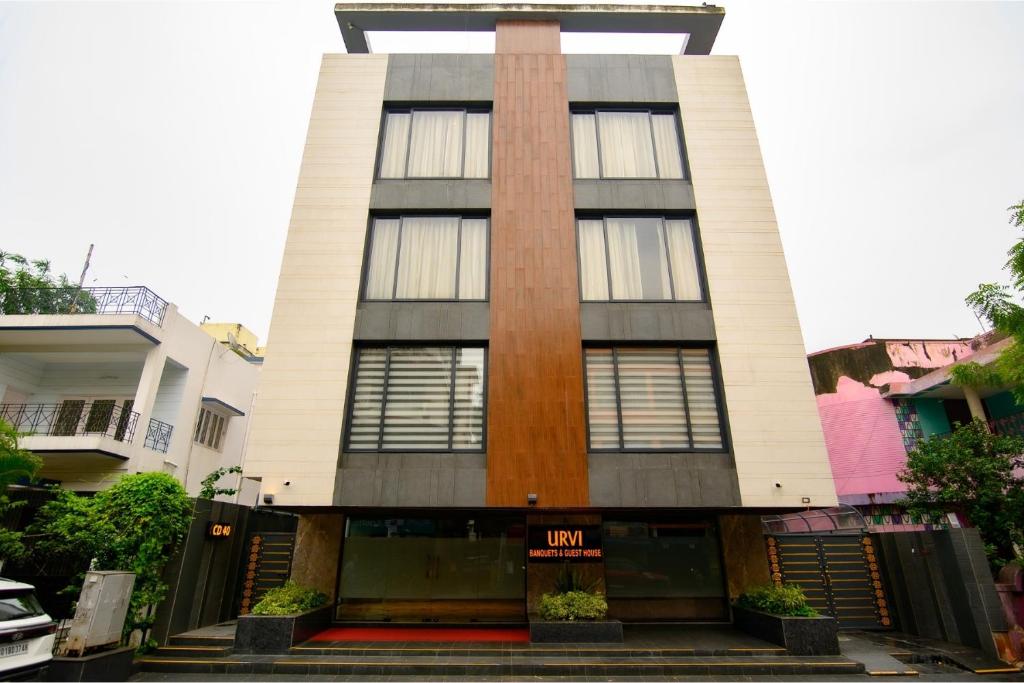 a tall building with a sign in front of it at Urvi Banquets & Guest House in kolkata