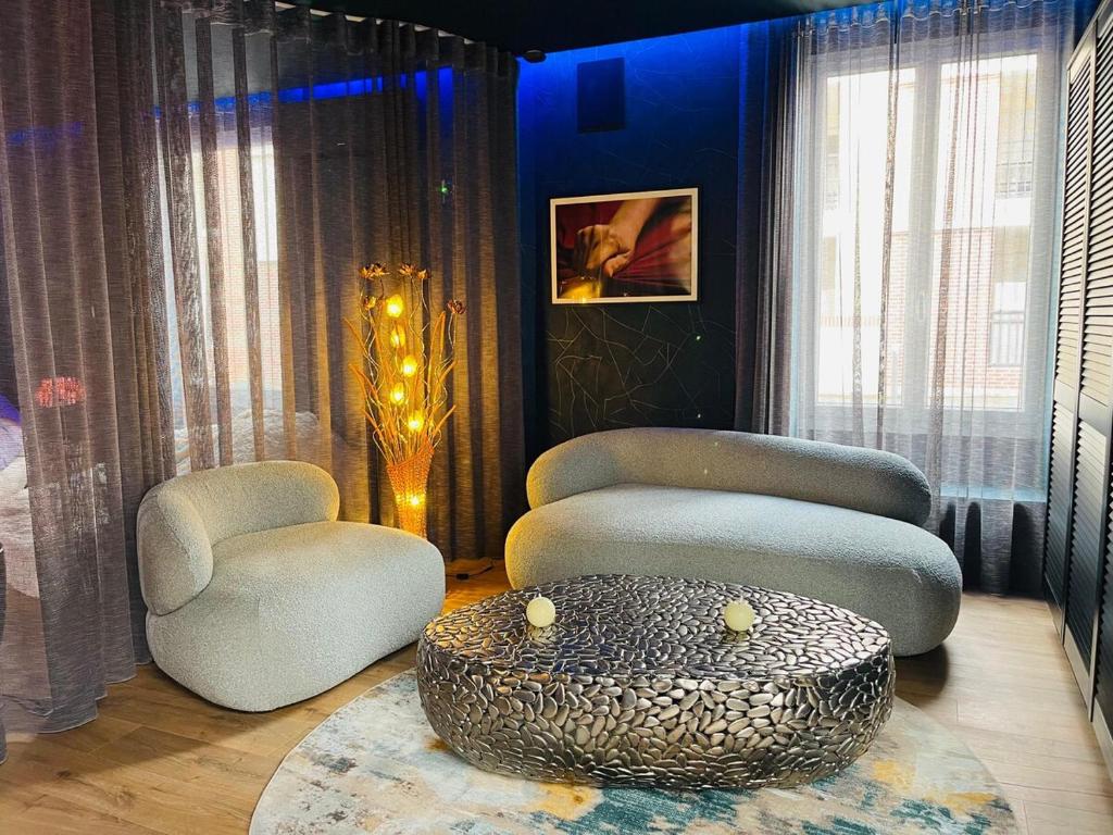 a living room with two chairs and a table at La suite Emois et Toi in Orléans