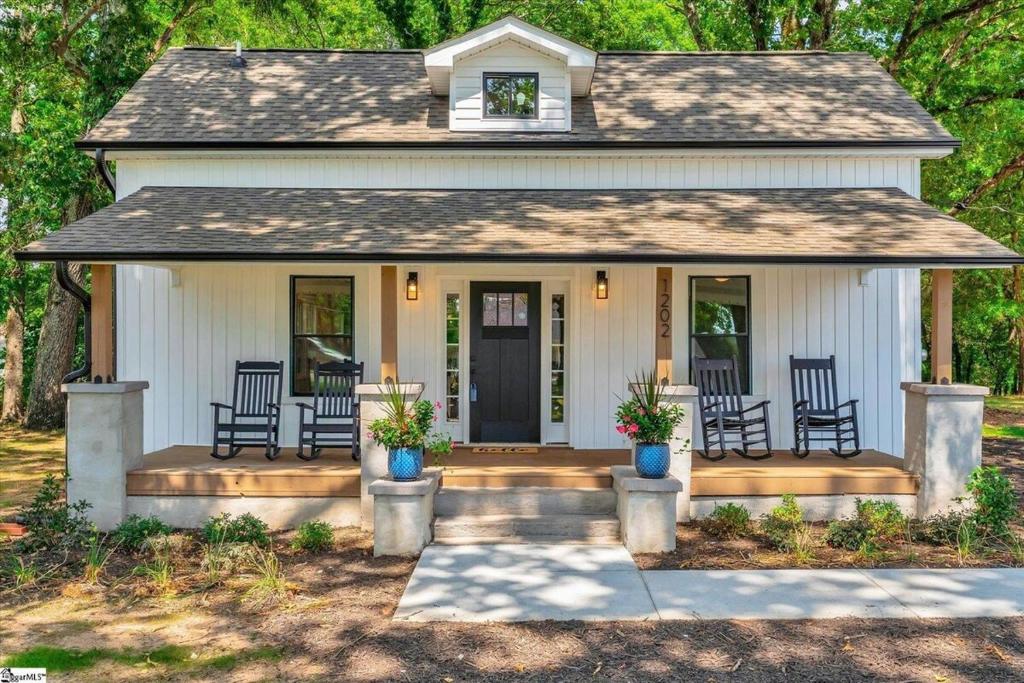 a small white house with chairs on a porch at Welcome to Villa Rosa Farmhouse in Piedmont