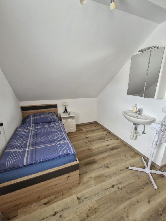 a bedroom with a bed and a sink at Apartment in Gaspoltshofen