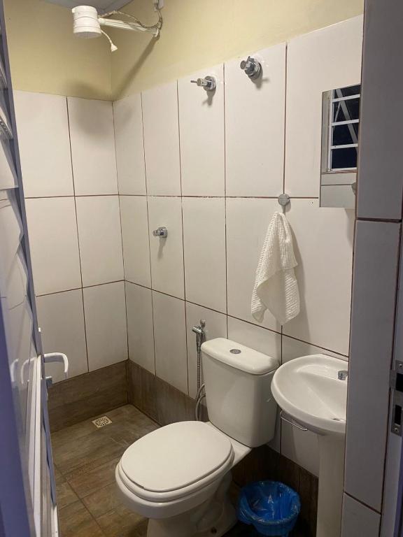 a bathroom with a toilet and a sink at Rancho Royer in Araguari