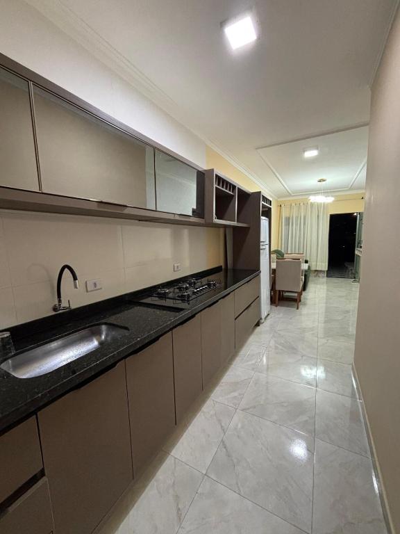 a kitchen with a sink and a counter top at Furnished house in Fazenda Rio Grande