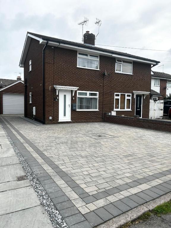 a brick house with a driveway in front of it at Wessex Stays - Spacious 1 Bedroom Property in Willaston
