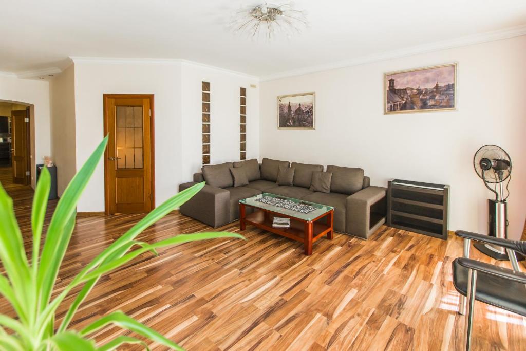a living room with a couch and a coffee table at Apartamenty u centri Lvova - Lviv in Lviv