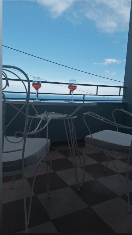 two chairs and a table on a balcony with a view at Noma apartment in Gythio