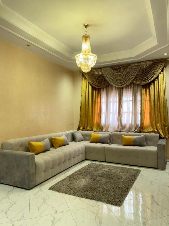 a living room with a couch in front of a window at Modern apartment in Oujda