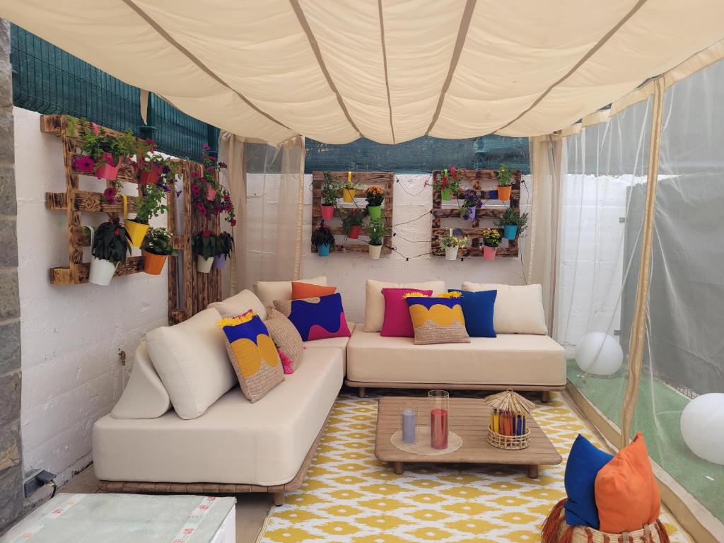 a living room with a white couch and colorful pillows at Llanesmar in Posada de Llanes
