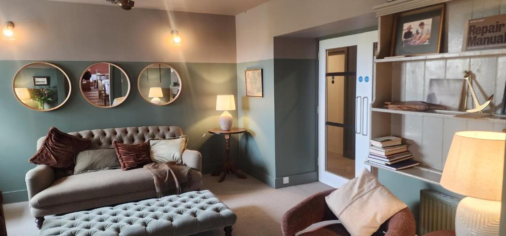 a living room with a couch and mirrors on the wall at Doonmore Hotel, Bar & Restaurant in Inishbofin