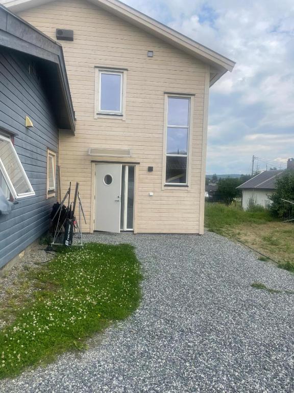a house with a gravel driveway in front of it at Senator appartment with 3 bedrooms near Oslo Airport in Råholt