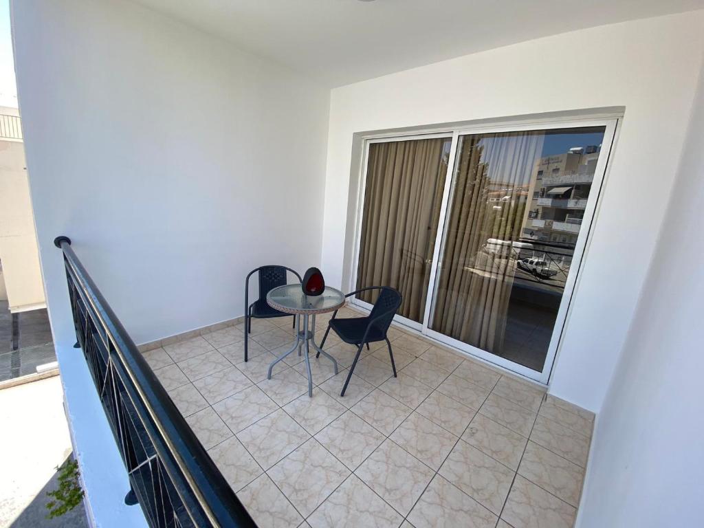 a balcony with a table and two chairs on it at 2 bedroom flat in Paphos in Paphos City