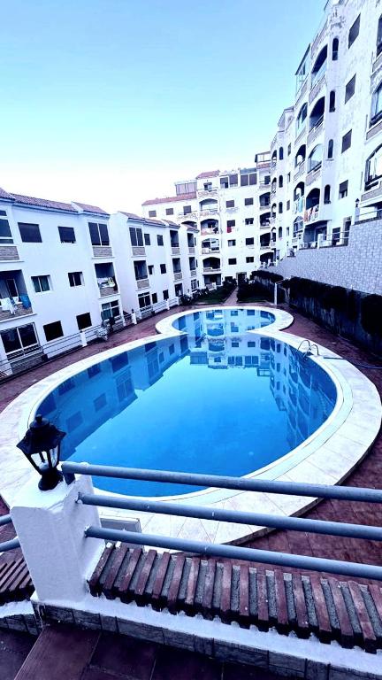 a large swimming pool in front of a building at Appartement Oued Laou Mekkad in Oued Laou