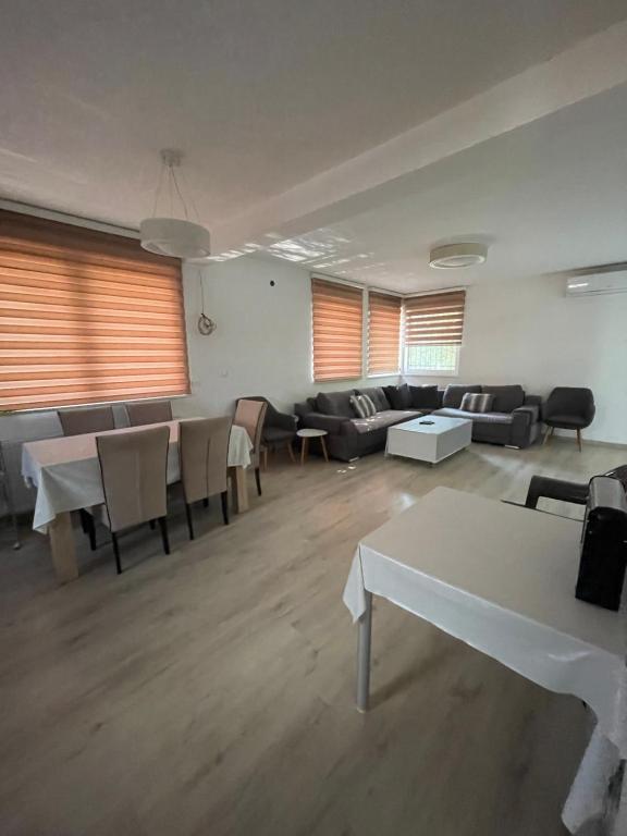 a large room with tables and couches and chairs at Aia Holiday Home in Sarajevo