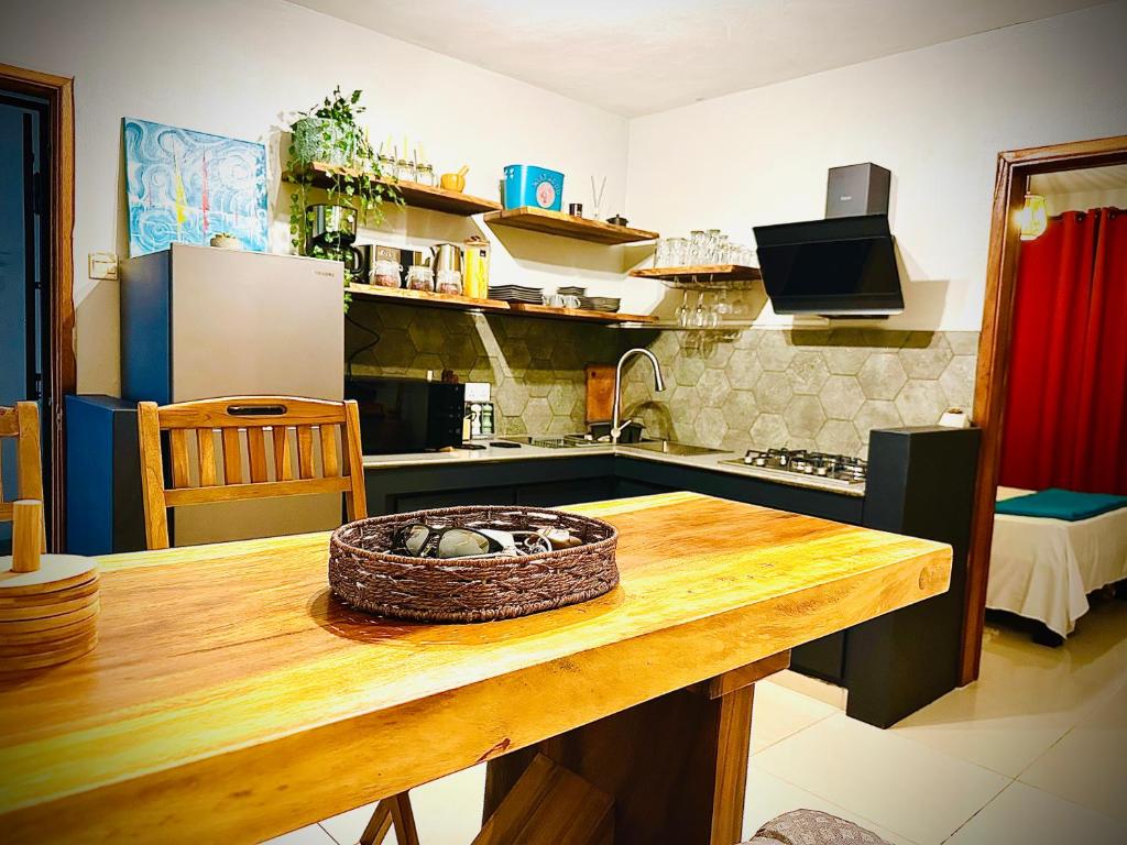 a kitchen with a table with a basket on it at Flic en Flac Beachfront Apartment, KAZAFIBI in Flic-en-Flac