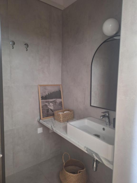 a bathroom with a sink and a mirror at Noma apartment in Gythio