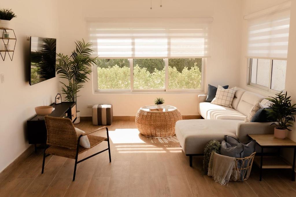 a living room with a couch and a table at House of Flores Villa Bavaro in Punta Cana