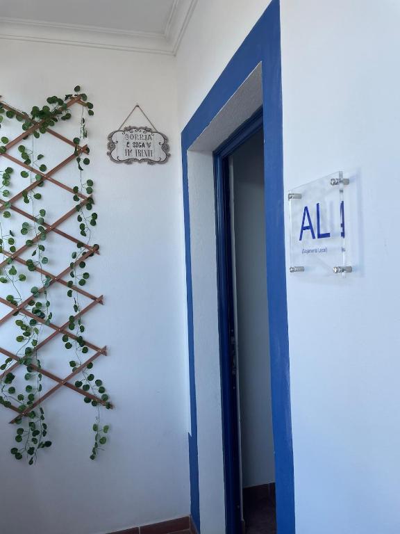 a room with a sign and a plant on the wall at A Casa da Cilarca in Portel