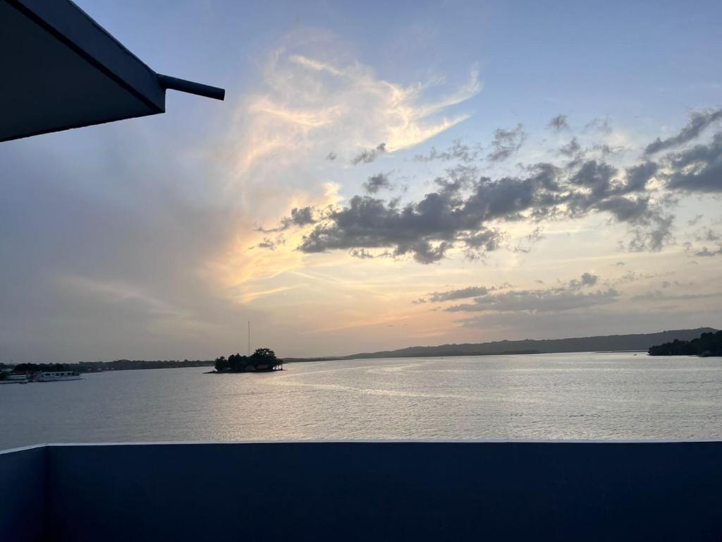 a view of a body of water at sunset at Tikal Sunrise House in Flores