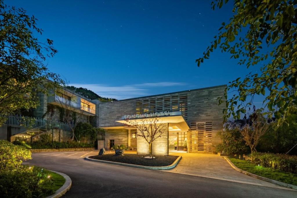 a large building with a road in front of it at Songmo Hotel in Huzhou