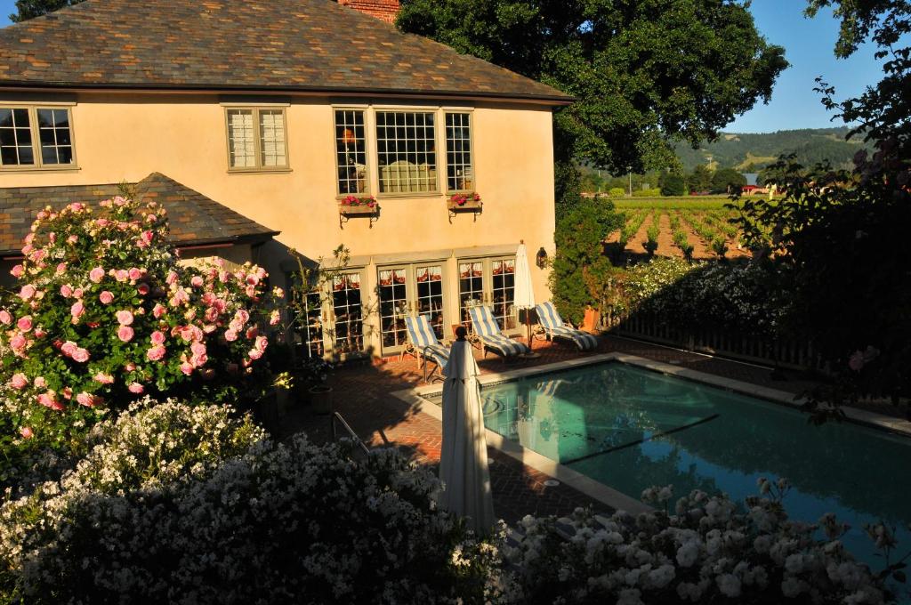 a house with a swimming pool in the yard at Vineyard Country Inn in St. Helena