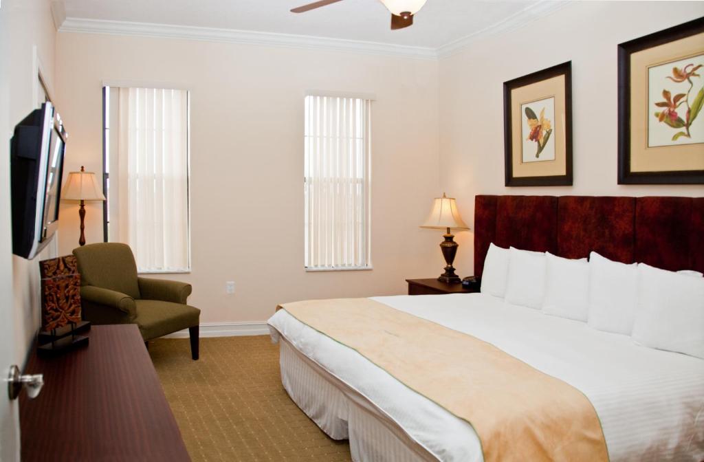um quarto de hotel com uma cama e uma cadeira em Emerald Greens Condo Resort em Tampa