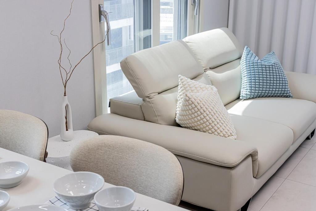 a living room with a white couch and a table at The Osiria in Busan