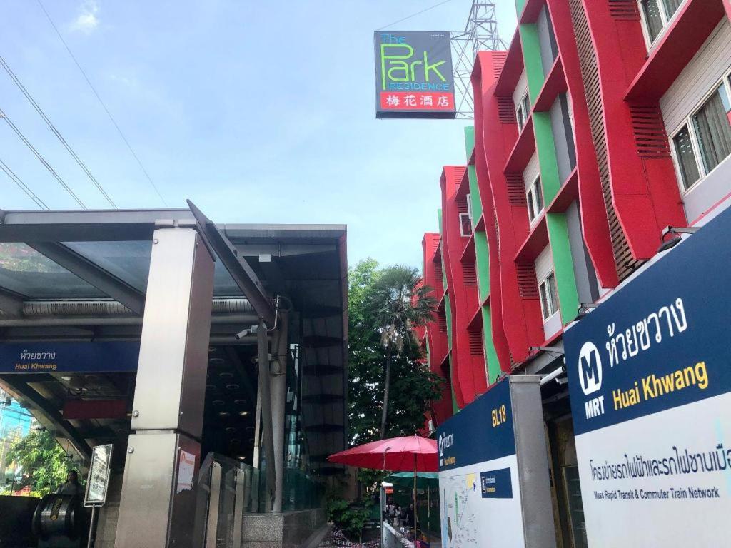 a building with a sign on the side of a street at The Park Residence in Bangkok