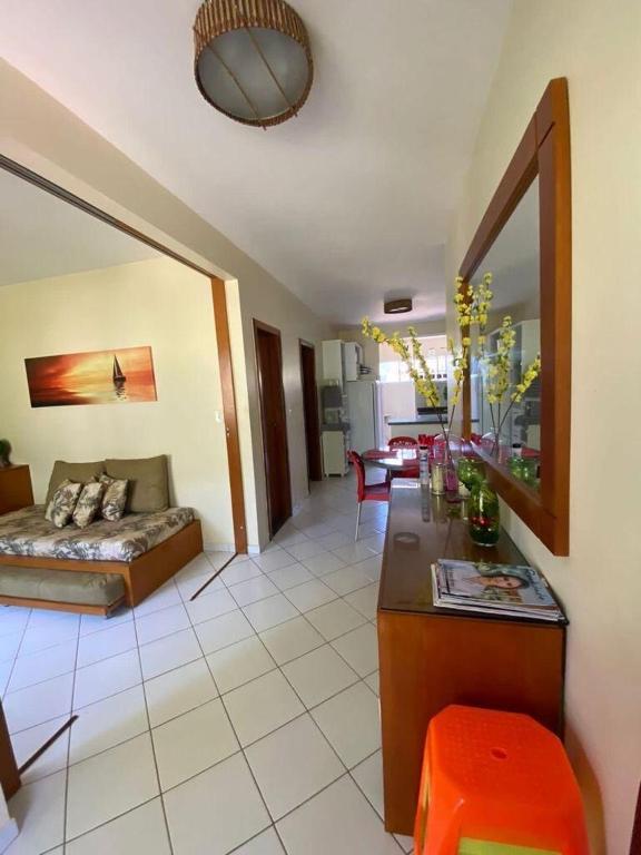 a living room with a couch and a table at Village Japara in Ilhéus