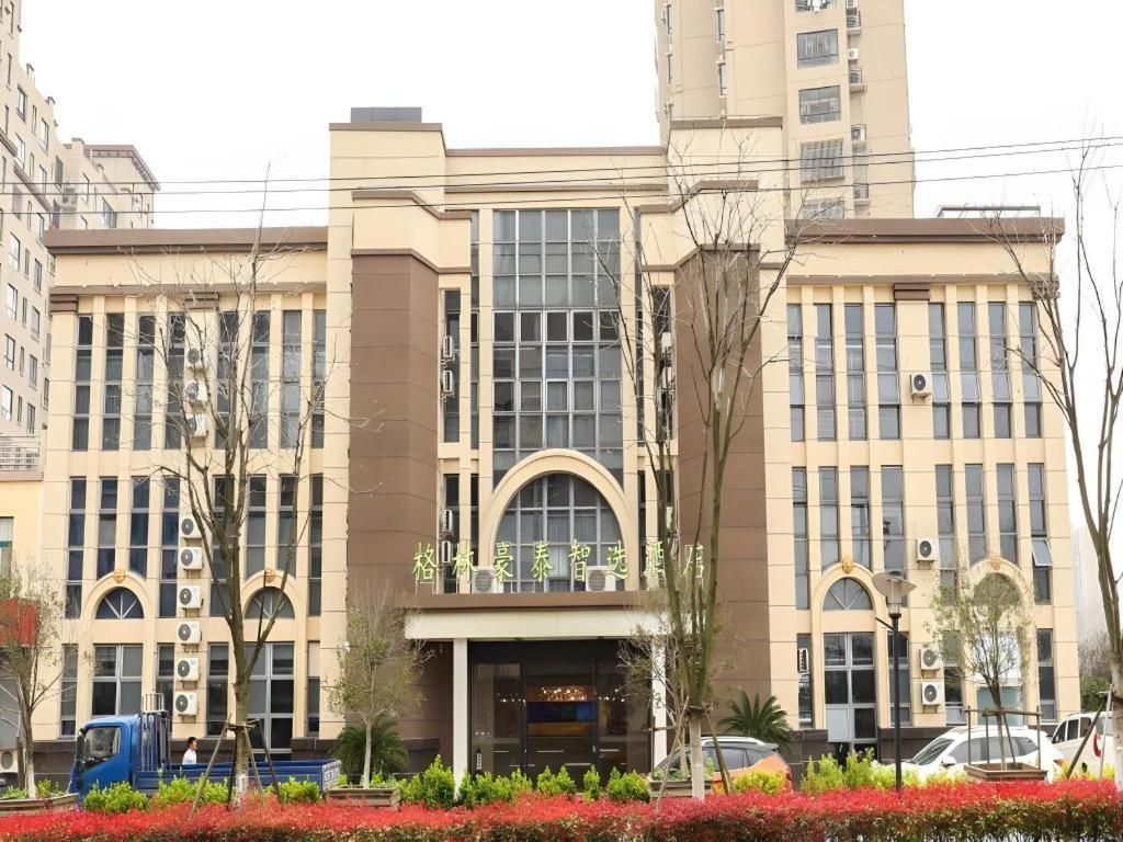 a large building with a lot of windows at GreenTree Inn Suzhou Changshu Southeast Development Zone Southeast Avenue in Gujiashuigou