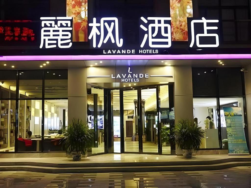a building with a sign for a luxury hotel at LAVANDE Hotel Dalian Huanan Square North Railway Station in Dalian