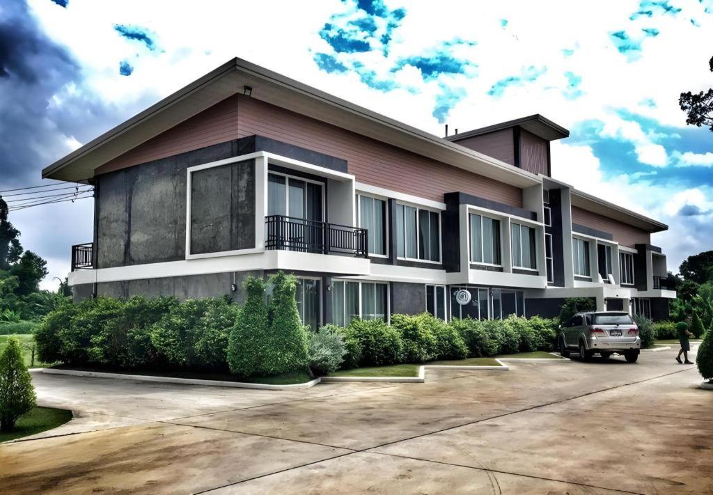 a house with a car parked in front of it at Loft Village in Ban Khlong Kathon