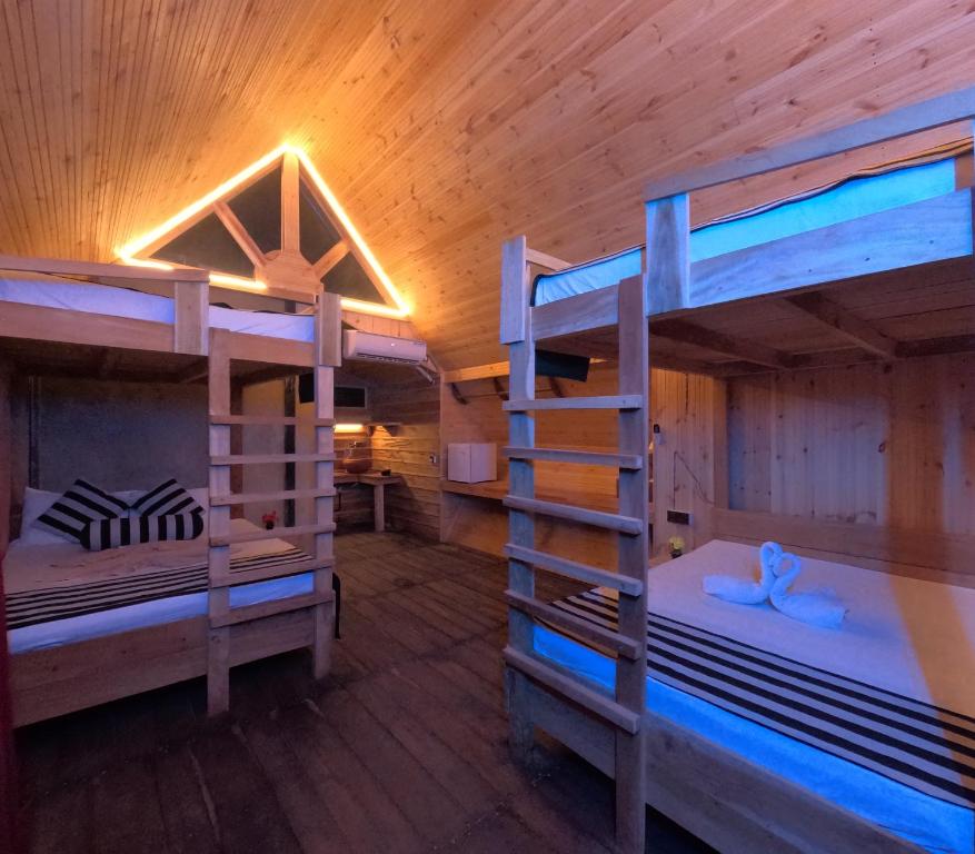 a room with two bunk beds in a cabin at Gisban Wood Cabana & Hostel in Habarana