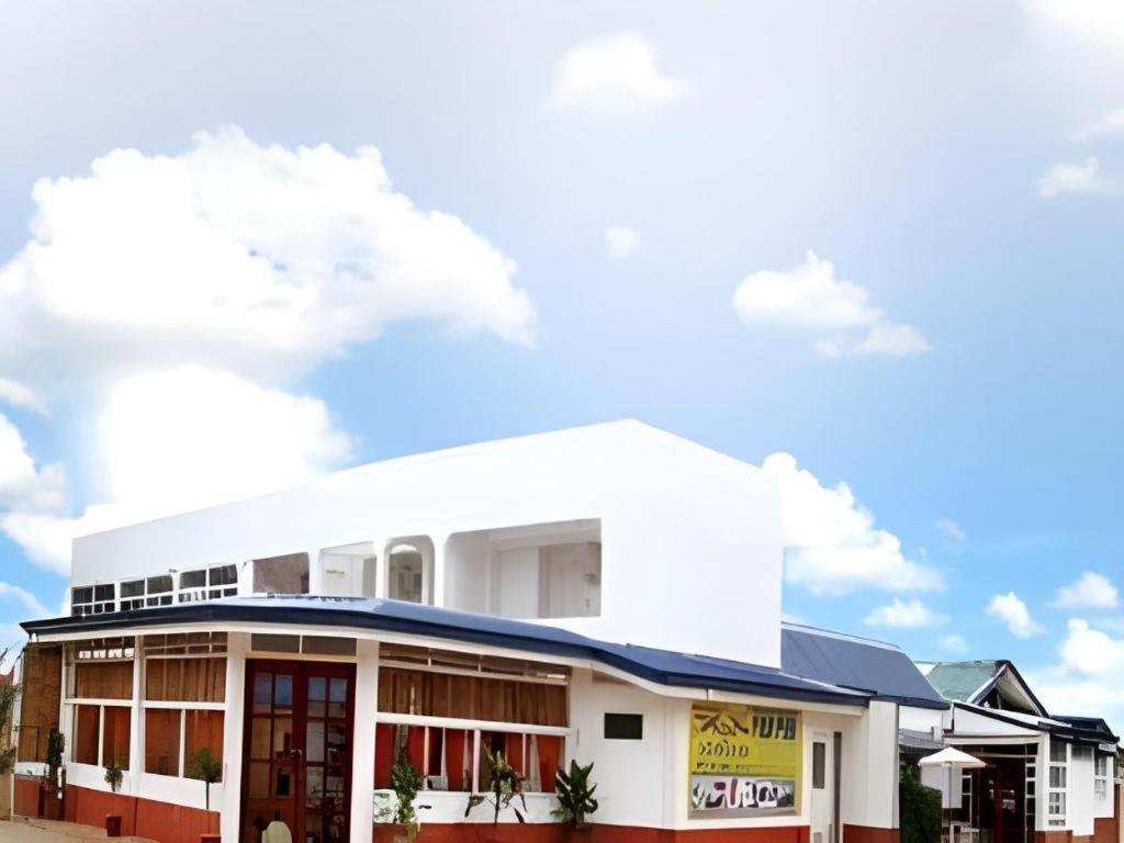 a white building with a blue sky in the background at House of Big Brother in Puerto Princesa City