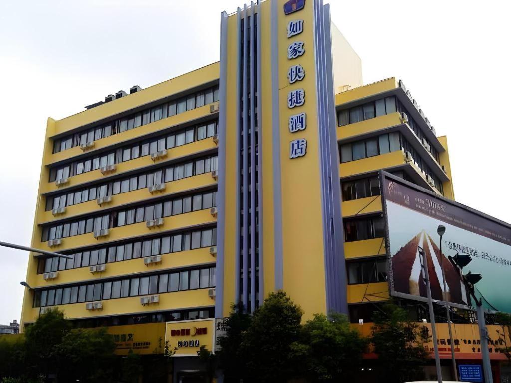 a large yellow building with a clock on it at Home Inn Kunming Baita Road in Kunming