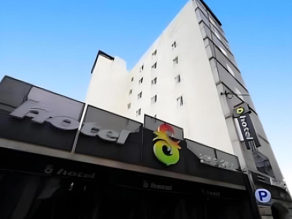 a tall white building with a sign in front of it at Hotel S Shinchon in Seoul