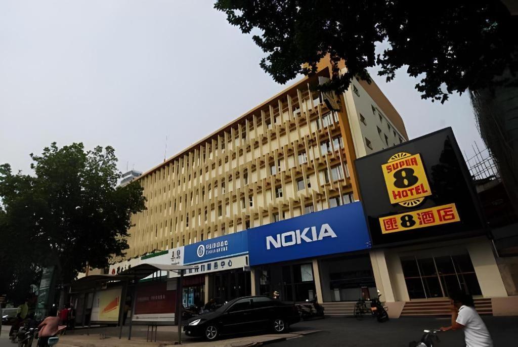 a nikka building with a car parked in front of it at Super8 Hotel Anyang Hongqi Road in Anyang