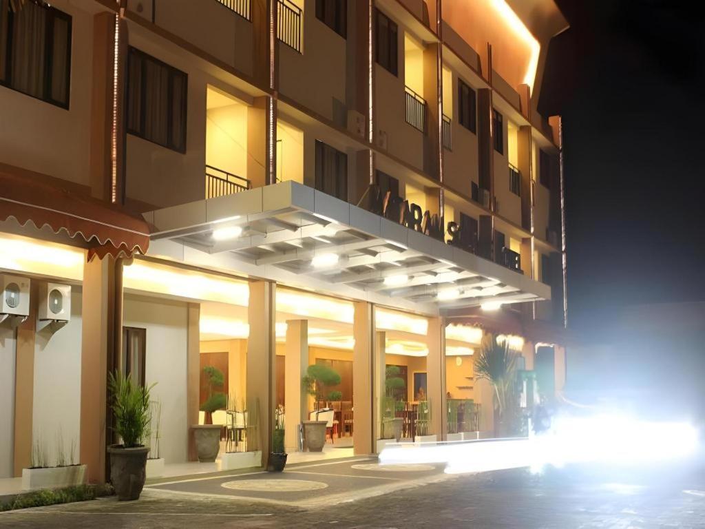 a building at night with lights in front of it at Mataram Square Hotel in Gili Trawangan