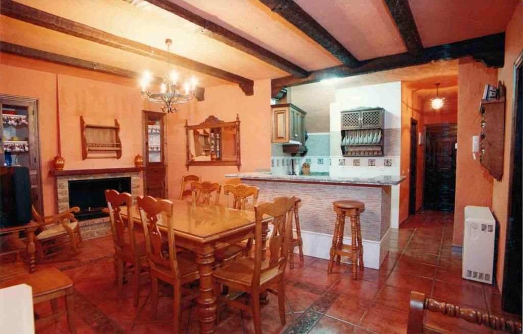 a dining room with a table and a kitchen at Marqueño Turismo Rural in Vianos