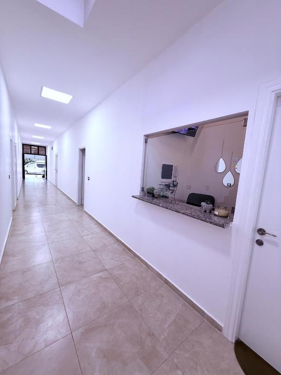 a hallway with a large mirror on a white wall at Villa JURGEN in Durrës